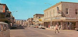 Here is a fun snapshot from a more recent "historical" era. McCoy's  Pharmacy and Hoovers Shoe Store feature prominently in this image. And the  cars help tell the story. What memories does