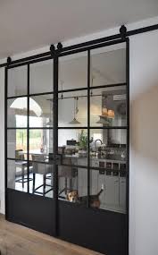 A Classic Industrial Design Door On Rollers Than Can Keep A Small Space Open Due To The Thin Pane Braces Yet Allow Glass Barn Doors Barn Door Designs New Homes