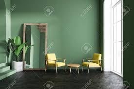 Brighten your living room by working yellow into the palette. Yellow Armchairs Living Room Interior With Green Walls Loft Stock Photo Picture And Royalty Free Image Image 102014306
