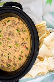 Loaded queso in a tortilla bowl. Crock Pot Queso With Beef Sausage