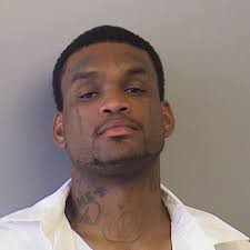 Police find murder suspect already behind bars; girlfriend arrested as an  accessory