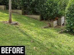 Rocks spread throughout the slope in a random pattern mixed with greenery and flowers. How To Build A Retaining Wall In The Backyard Australian Handyman Magazine