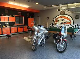 Harley man cave garage make over by custom storage solutions designed with pvc flooring in a decorative pattern silver, black and gray color. Harley Garage Garage Specialties