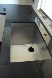 Modern black kitchen countertop steel backsplash. Pin By Lacy On House Options Quartz Kitchen Countertops Quartz Countertops Black Quartz Countertops