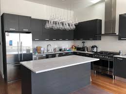 Modern Kitchen With Espresso Cabinets Bulb Chandelier Stainless Steel Appliances Silver Hardware Ha Open Kitchen Layouts Kitchen Layout Large Open Kitchens