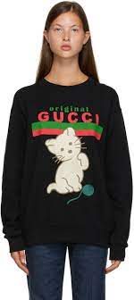 The intense red with the angry cat applique makes a perfectly trendy combination. Gucci Black Original Gucci Cat Sweater Editorialist