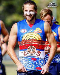 The guernsey will be worn by the players for sir doug nicholls round, on friday may 28 against. Afl On Instagram The Westernbulldogs 2020 Indigenous Guernsey First Unveiled Last Year Was Created By Renowned Indigenous Artist Afl Patterson Mens Tops