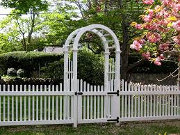 A saint joseph, missouri contractor transformed an ordinary white picket fence to an extraordinary white picket fence with the addition of a a funky gate in a bold, contrasting color adds personality to a white picket fence. Wood Fences Malone Fence Company