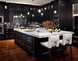 The Black Cabinets In This Kitchen Really Seem Bold And Elegant With The Teardrop Style Lighting Wi Modern Black Kitchen Interior Design Kitchen Home Kitchens