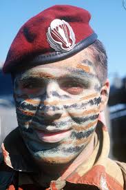 A member of the Italian 5th Paratrooper Battalion, wearing camouflage paint 