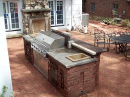 It includes a grill, maybe a pizza oven, a sink, some storage space and cooking countertops. Detail Outdoor Bar Grill Sink Yoder Masonry Inc