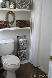 This tiny bathroom is made to feel much larger by the inclusion of mirror all around the room. Gray Bathroom Colors Cottage Bathroom Glidden Fossil Grey 320 Sycamore