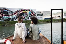 In the harbor of linz are a lot of huge warehouses, containers, cranes and railways. Mural Harbor Linz Tourismus