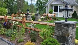The split rail, or post and rail, fence is essentially a rustic version of a post and board fence style and is similarly a good choice for a decorative accent, for typically made from split cedar logs, the fence materials have naturally random shaping and dimensions, with imperfect details and character marks. Stone Posts And Wood Fence Imagine Adding Sleeker Posts And Trellis In The Yard For Asthetics Https Fence Landscaping Split Rail Fence Driveway Landscaping
