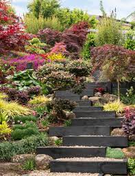 This Auckland Garden Was Transformed From A Bare Slope Into A Zen Oasis Sloped Backyard Landscaping Sloped Garden Backyard Landscaping