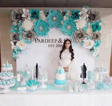 Themed bridal shower with photo booth props, tiny cakes and glamorous decorations! Tiffany Blue Themed Paper Flower Wall For Such A Gorgeous Bride To Be Flower Wall Tiffany Blue Bridal Shower Tiffany Bridal Shower Bridal Shower Brunch