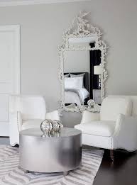 White Baroque Mirror In A Transitional Bedroom Joins With Plush White Accent Chairs And A Rou In 2020 White Accent Chair Transitional Bedroom Bedroom With Sitting Area
