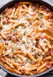 Italian Sausage Pasta In A Skillet Being Dished Out With Wooden Spoon Italian Sausage Pasta Italian Sausage Recipes Hot Italian Sausage Recipes