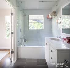 Shower Over Bath With Glass Door And Window Dark Floor And White Marble Counter Bathroom Tub Shower Combo Bathtub Shower Combo Bathroom Tub Shower