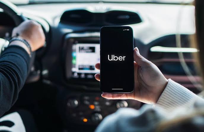 Uber app on a phone in a car