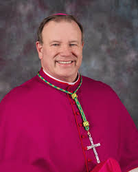 A priest of high rank who is in charge of the priests of lower rank in a particular area: Our Bishop Diocese Of Alexandria