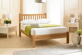 Fabric bed with footboard shown in antiqued grey oak with graphite vintage velvet. Emporia Milan Solid Oak Bed From The Bed Station