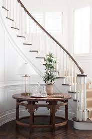 All wood table tops are custom made to order. Foyer Area With Curved Staircase And A Round Wooden Table Orrick And Company Staircase Decor Foyer Decorating Entryway Stairs