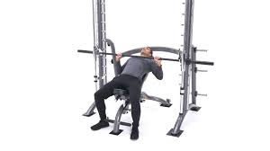 Lie flat on your back on a bench directly underneath the barbell of a smith machine. Smith Machine Incline Bench Press Exercise Videos Guides Bodybuilding Com