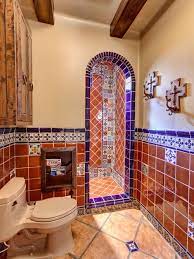 The cabinet drawers share the stark whiteness of the tub, ceiling and the upper half of the walls which are further brightened by the pin lights and french window above the bathtub. Mexican Tiles In A Bathroom Spanish Style Bathrooms Spanish Style Bathroom Mexican Kitchen Decor
