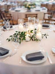 Foliage is among the most versatile of wedding table decorations. Lush Garden Wedding With Greens Galore Cheap Wedding Centerpieces Greenery Wedding Centerpieces Wedding Centerpieces