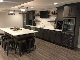 A pub style bar is the focal point upon entering this space featuring brick niches and wooden hammer solid walnut countertops. Finished Basement Bar Basementremodeling Finished Basement Bars Basement Bar Designs Basement Bar