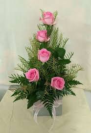 Pink Roses Are Used To Form A Line Overall This Arrangement Is Triangular Shap Rose Flower Arrangements Church Flower Arrangements Flower Arrangements Simple