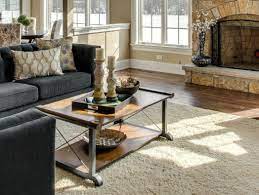 A grouping of books topped with dazzling objects occupies each portion. How To Decorate A Coffee Table Chicagoland Home Staging