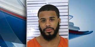 Man charged after two have car stolen at gunpoint in Davenport