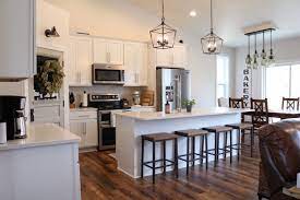 An open concept floor plan elevates the kitchen to the heart and functional center of the home, often featuring an island that provides extra counter space and a snack bar with seating. Farm House Open Concept Modern Farmhouse Kitchen Novocom Top