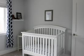 This modern eclectic baby boy's nursery has gray walls and white trim. White Gray And Navy Baby Boy Nursery A Fit Mom S Life