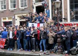 Before the match psv hooligans attack the arsenal firm in the citycenter,chairs bottles knives tables forks spoons ect. Hooligans News As English