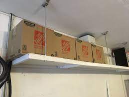 My Solution For Overhead Storage In Our Garage Requiring Lagging Into Concrete Walls And Hung From Finished Ceilings Overhead Storage Storage Plywood Shelves