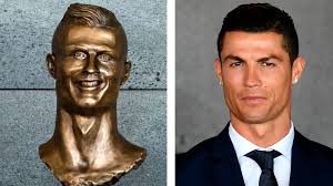 Cristiano ronaldo from real madrid poses during the unveiling ceremony of a statue of himself in his hometown of funchal, madeira island on december 21, 2014. Ronaldo Bust Looks Nothing Like Ronaldo And The Internet Notices The New York Times