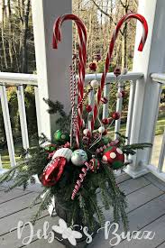 Create your own with two candy canes tied with brown pipe cleaners. Diy Lighted Candy Cane Christmas Urns Add Whimsy Debbee S Buzz