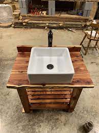 We use reclaimed barn wood, reclaimed fence wood, rustic hickory, rustic cedar, willow, butter nut, walnut. Cedar Vanity For Our Half Bath Old School Vessel Sink With Oversized Faucet Homemade Hand Rubbed Finish Thrifted Furniture Half Bath Vanity Bathroom Kids