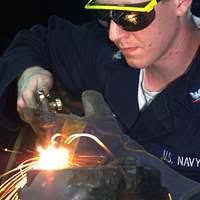 Ensign John Haddad checks the distance of surface contacts from the bridge  of the guided-missile destroyer USS Higgins (DDG 76) as the ship pulls out  of Fleet Activities, Yokosuka.