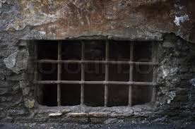 Photograph of an old eerie. Old Creepy Cellar Window With Bars Stock Image Colourbox
