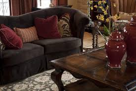 This contemporary living room space showcases its high ceiling with a primary beige paint color and a brown accent color above the fireplace. 7 Most Attractive Living Room Color Ideas For Brown Furniture In Your Very Own Space Jimenezphoto
