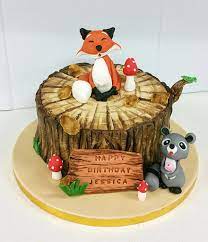 The cake is red velvet with cream cheese icing in between four layers of the cake and a. Fox On A Tree Stump And Raccoon Birthday Cake Cake By Cakesdecor