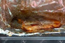 Chop and mash the garlic cloves with the sea salt to a chunky paste. Grilled Pork In Electric Oven On A Tray With Aluminum Foil Stock Photo Picture And Royalty Free Image Image 110531785
