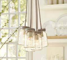 Decorative mason jar lanterns lit by candles, string lights, etc, to provide ambiance lighting. Exeter 5 Jar Chandelier Pottery Barn