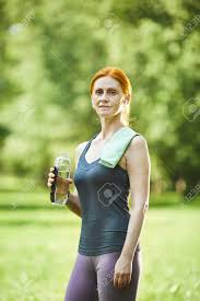 Huge collection of hot redhead porn! Portrait Of Smiling Confident Redhead Mature Woman With Towel On Shoulder Holding Bottle Of Water In Summer Park Stock Photo Picture And Royalty Free Image Image 151521680
