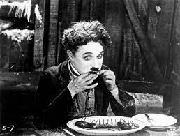 He tries to win her heart with his singular charm. The Gold Rush Film By Chaplin 1925 Britannica