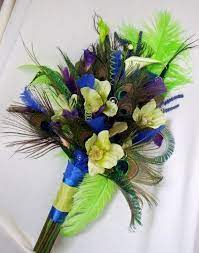 Purple silk decorates the handle of this bouquet, while green velvet ribbon streamers flutter in the. Pin By Lisa Froelich On Kaylen Wedding Bouquets Purple Blue Purple Wedding Bouquets Green Bouquet